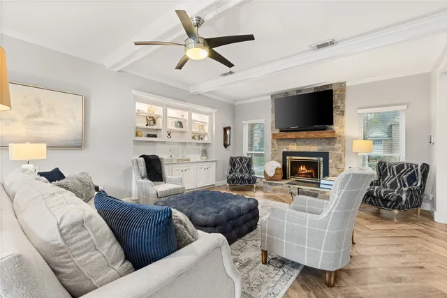 a living room with furniture a fireplace and a flat screen tv