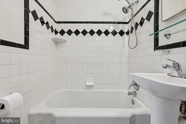 a bathroom with a bathtub and a sink