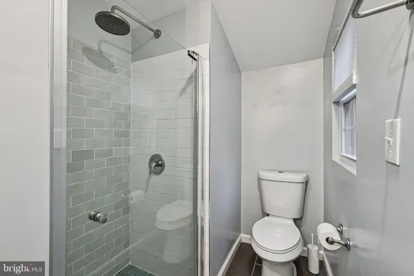 a white toilet sitting next to a bathroom sink