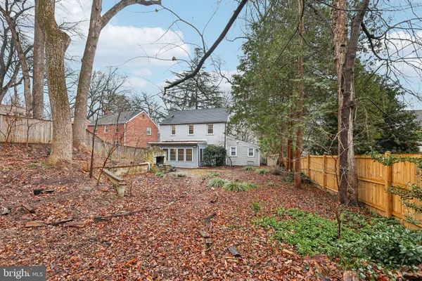 a view of a house with a large tree and a yard