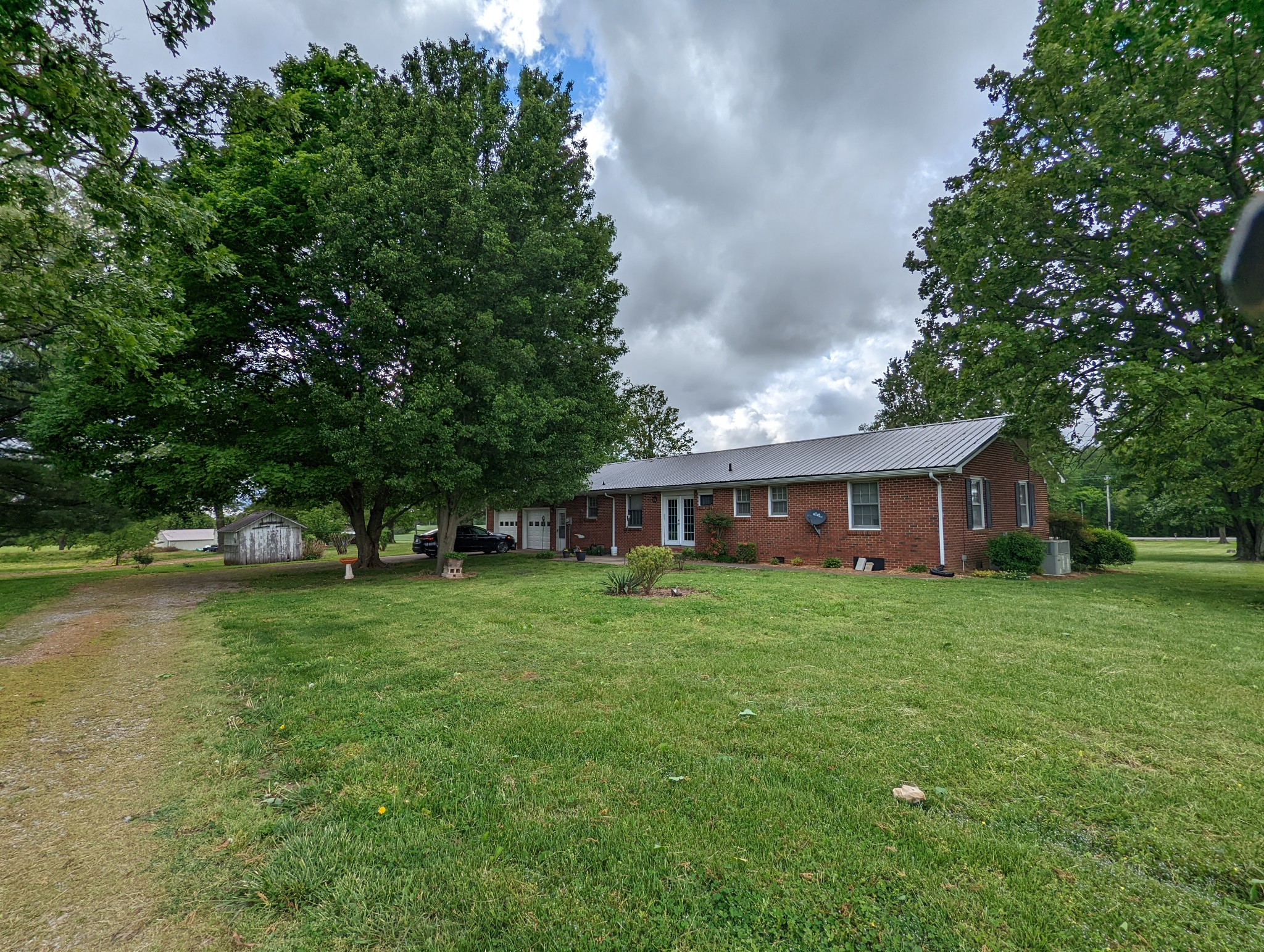 6765 Highland Road Portland, TN 37148 - Photo 29 of 31 a view of a house with a big yard potted plants and large tree