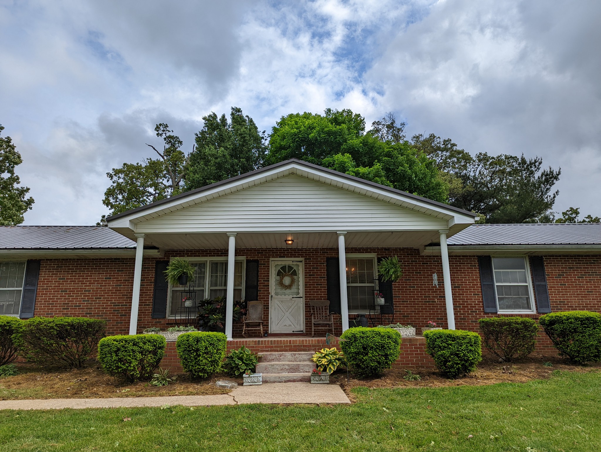 6765 Highland Road Portland, TN 37148 - Photo 4 of 31 a view of a house with a yard and plants