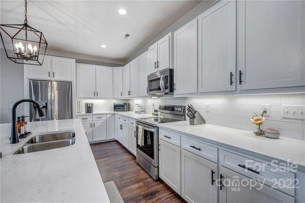 1388 Lawrence Road Clover, SC 29710 - Photo 16 of 48 a kitchen with white cabinets stainless steel appliances and sink