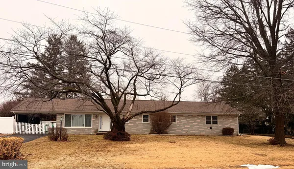 a front view of a house with a yard covered with snow in front of house