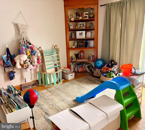 a room with furniture toys and a large window