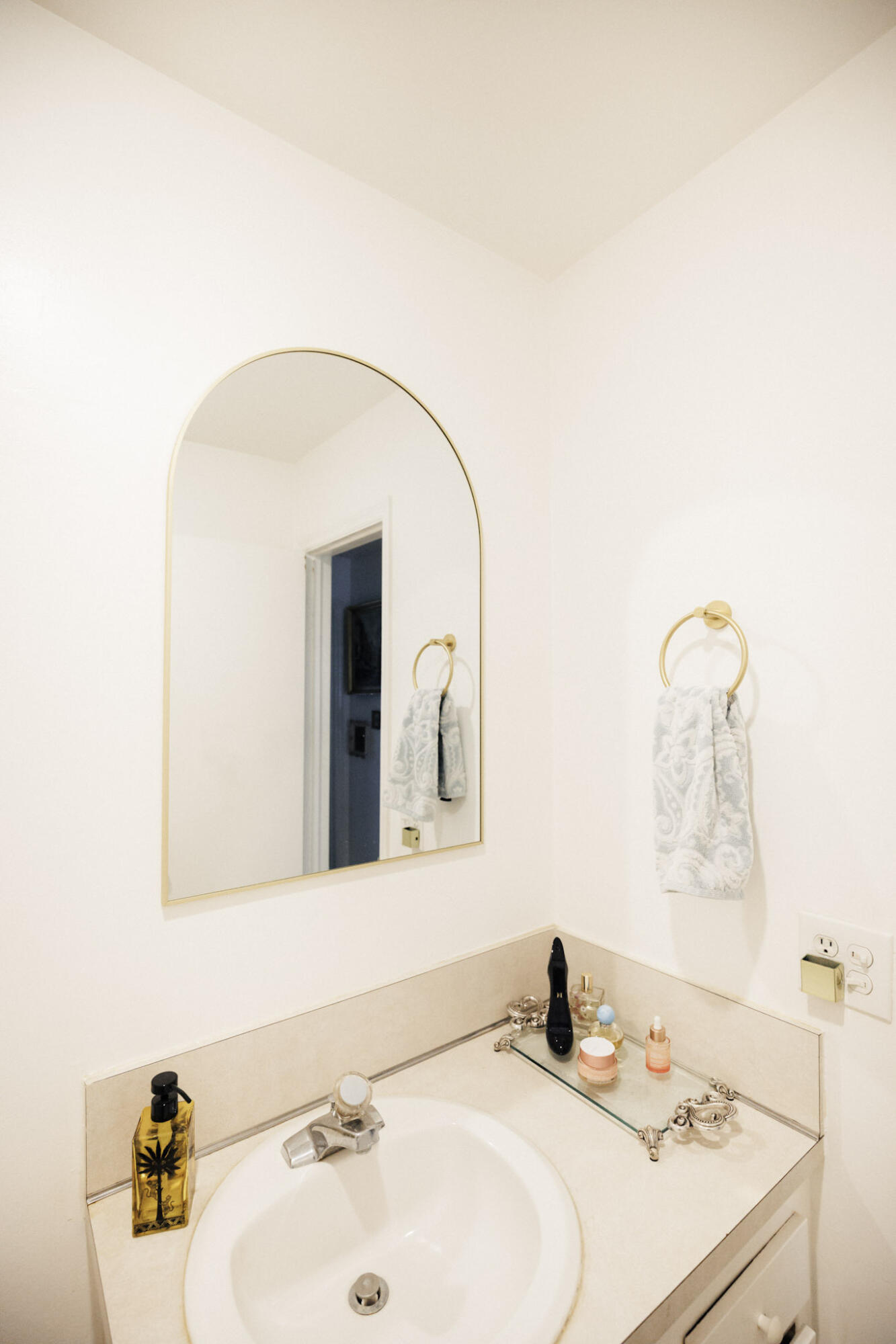 2403 Lowson Boulevard, Unit D Delray Beach, FL 33445 - Photo 14 of 21 a bathroom with a sink and a mirror