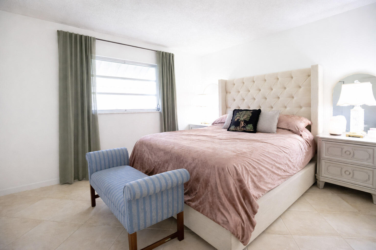 2403 Lowson Boulevard, Unit D Delray Beach, FL 33445 - Photo 15 of 21 a bedroom with a bed and a couch