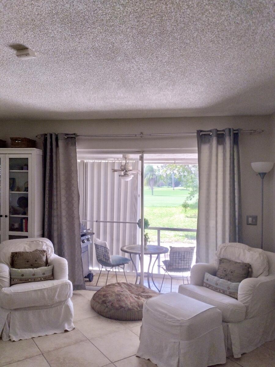 2403 Lowson Boulevard, Unit D Delray Beach, FL 33445 - Photo 9 of 21 a living room with furniture and a large window