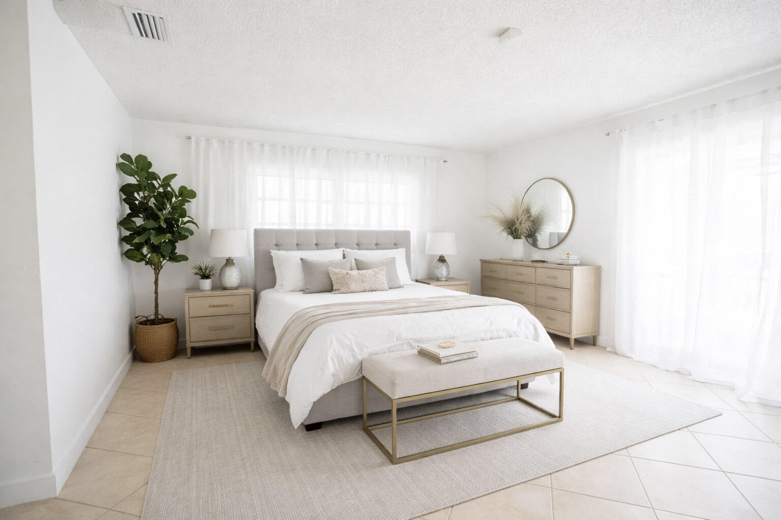 2403 Lowson Boulevard, Unit D Delray Beach, FL 33445 - Photo 10 of 21 a bedroom with a bed lamp and a potted plant