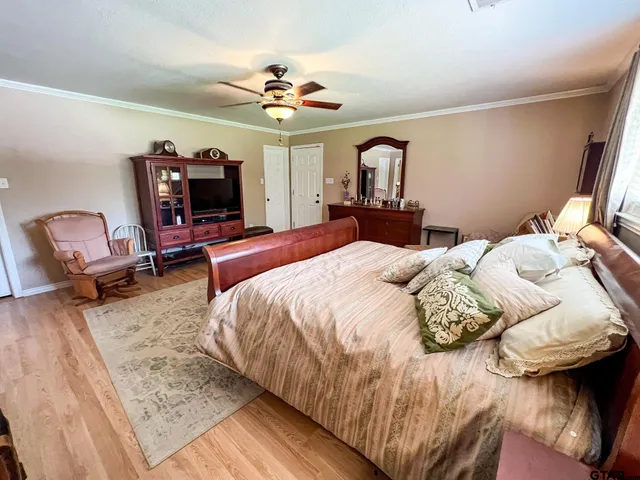 a bedroom with a bed and a chandelier