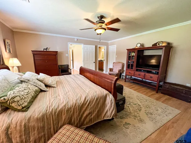 a bedroom with a bed and a television