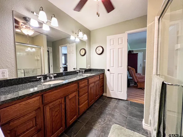 a spacious bathroom with a double vanity sink and a mirror
