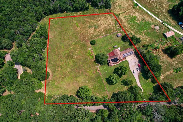 an aerial view of residential house with an outdoor space and street view