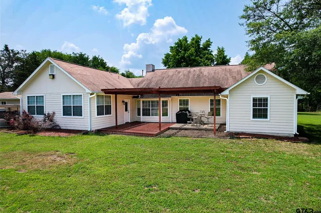 a front view of a house with a garden and patio