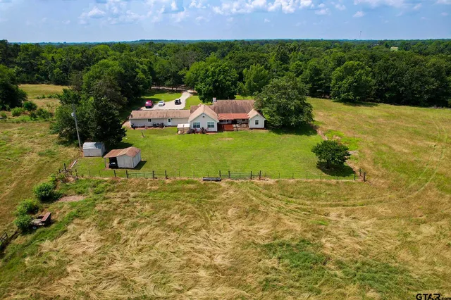 a view of a house with a yard and a large pool