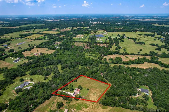 an aerial view of residential houses with outdoor space and river