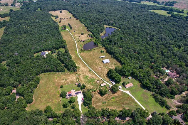 an aerial view of residential house with outdoor space and swimming pool