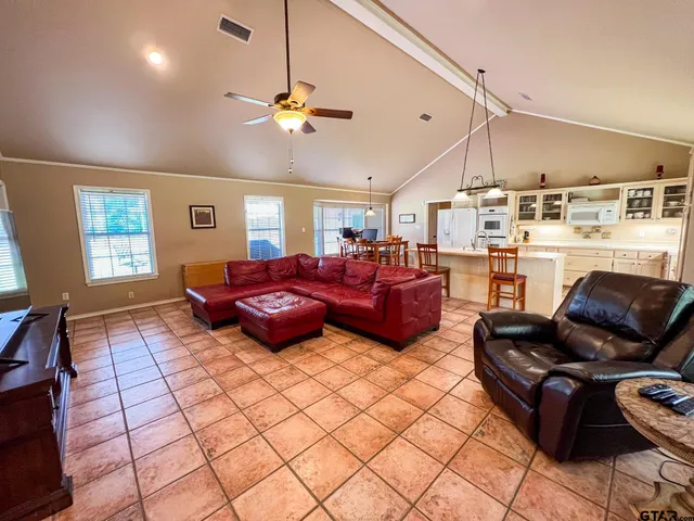 a living room with furniture ceiling and flat screen tv