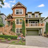 a front view of a house with a garden and plants