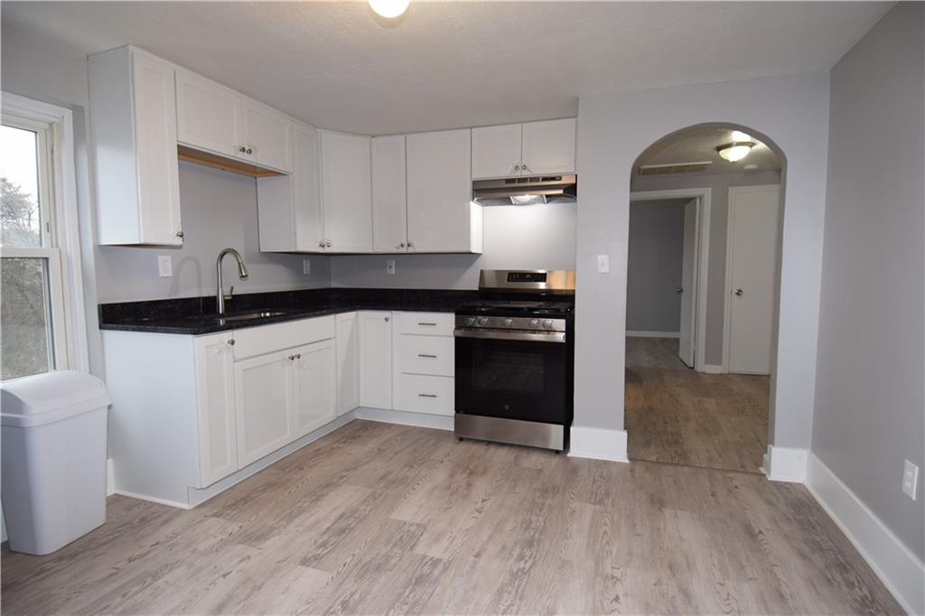 3224 Brodhead Road Aliquippa, PA 15001 - Photo 12 of 18 a kitchen with granite countertop a sink and a stove top oven
