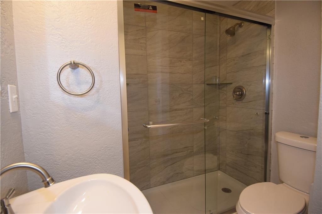 3224 Brodhead Road Aliquippa, PA 15001 - Photo 14 of 18 a bathroom with a toilet sink vanity and shower