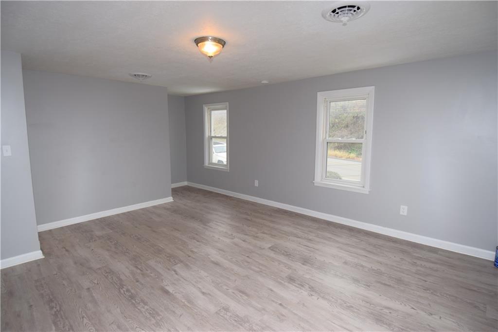 3224 Brodhead Road Aliquippa, PA 15001 - Photo 3 of 18 a view of an empty room with wooden floor and a window