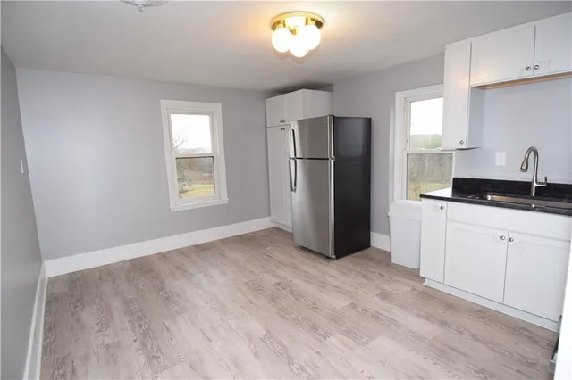 a kitchen with a refrigerator and a sink