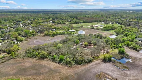 an aerial view of mountains with green space