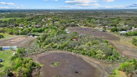 an aerial view of a houses with a yard