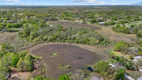 an aerial view of a houses with a yard