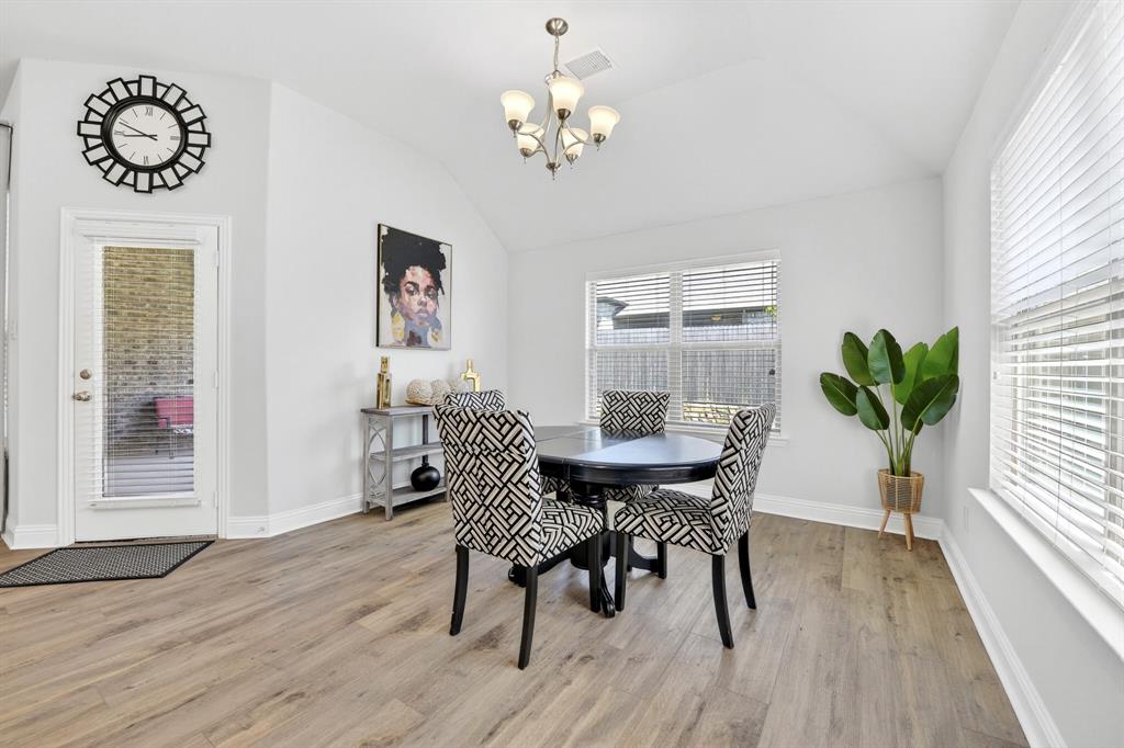 136 Gleeson Drive Red Oak, TX 75154 - Photo 16 of 40 a dining room with furniture a chandelier and wooden floor