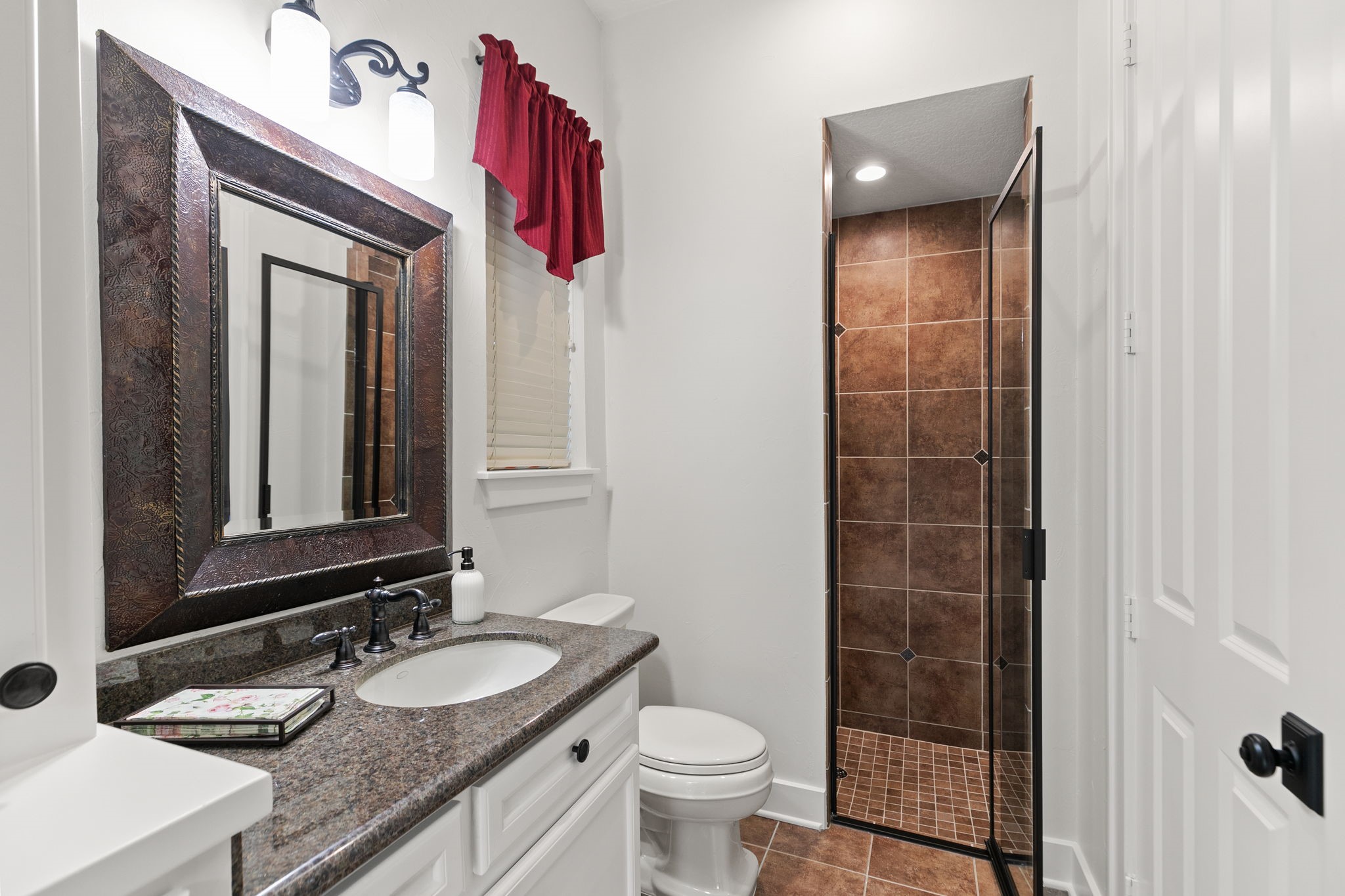 15601 Brown Road Tomball, TX 77377 - Photo 24 of 48 a bathroom with a granite countertop sink a toilet and shower