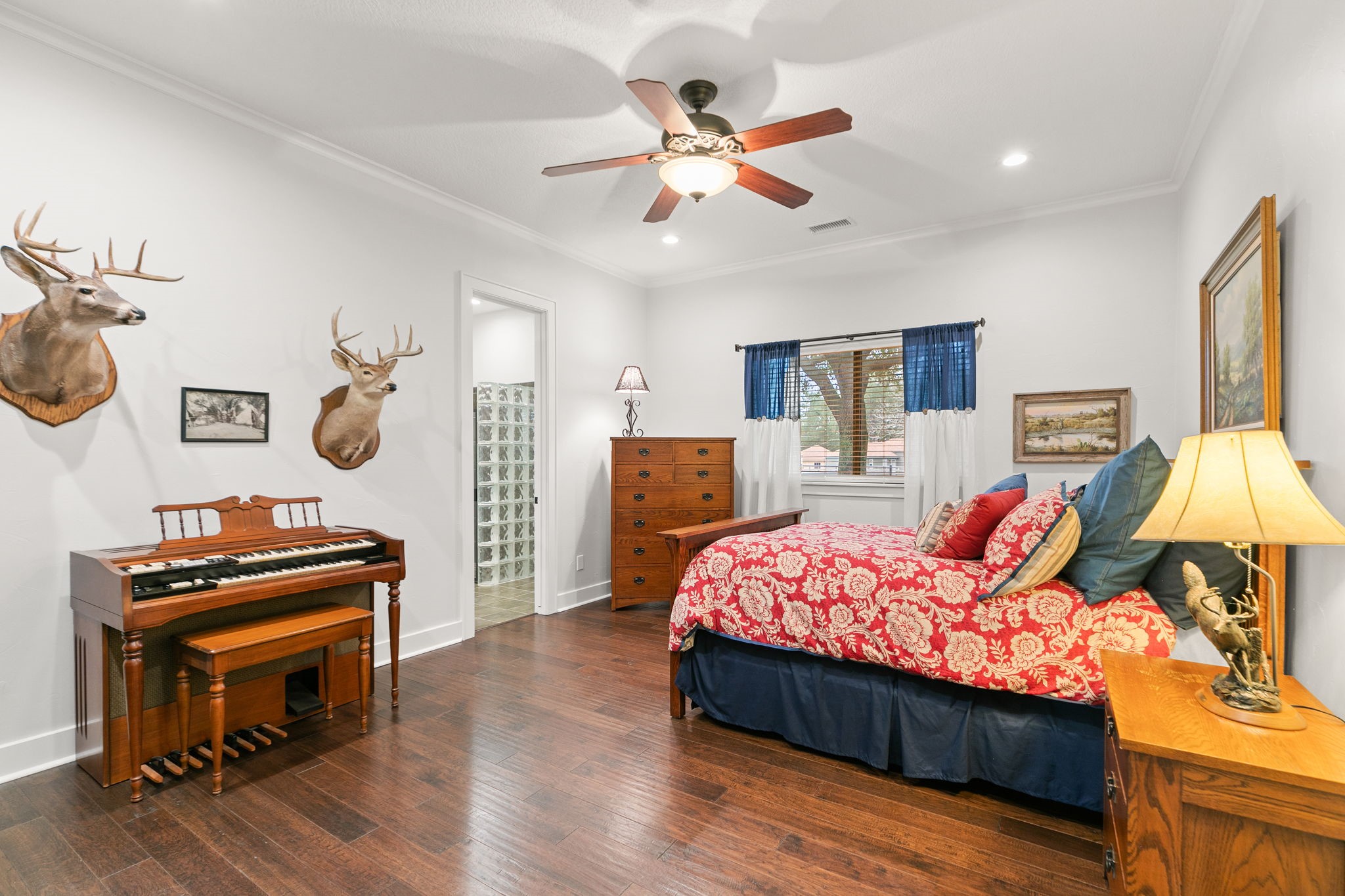 15601 Brown Road Tomball, TX 77377 - Photo 25 of 48 a bed room with a bed and a chandelier