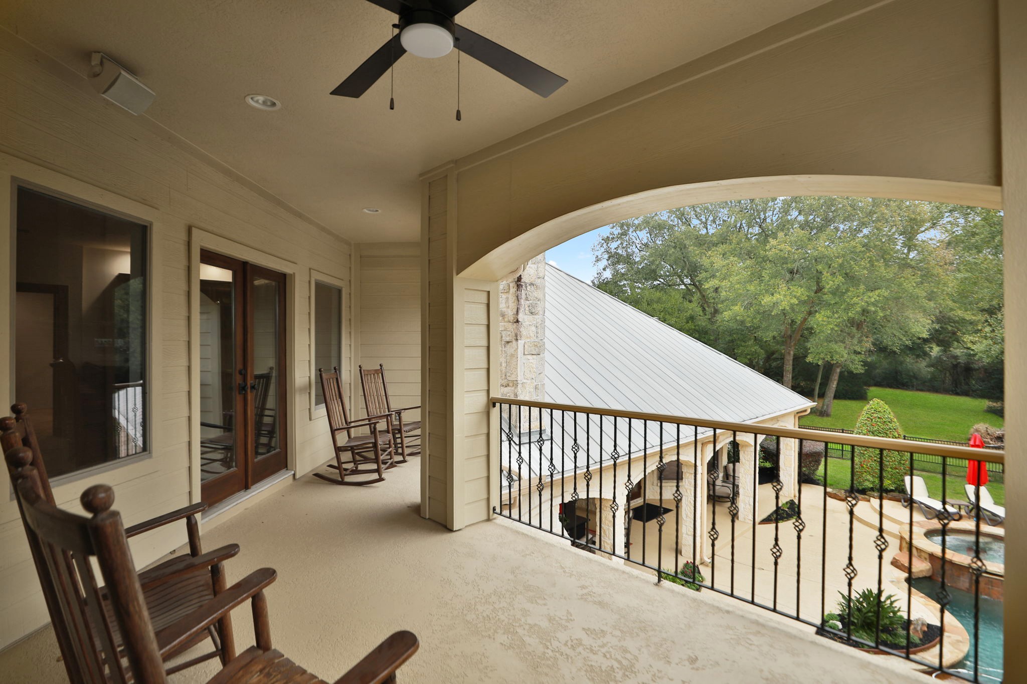 15601 Brown Road Tomball, TX 77377 - Photo 35 of 48 This spacious covered balcony off of the game room features a ceiling fan and overlooks a lush backyard with a pool and patio area, offering a serene and relaxing atmosphere. Plenty of room for your outdoor furniture!