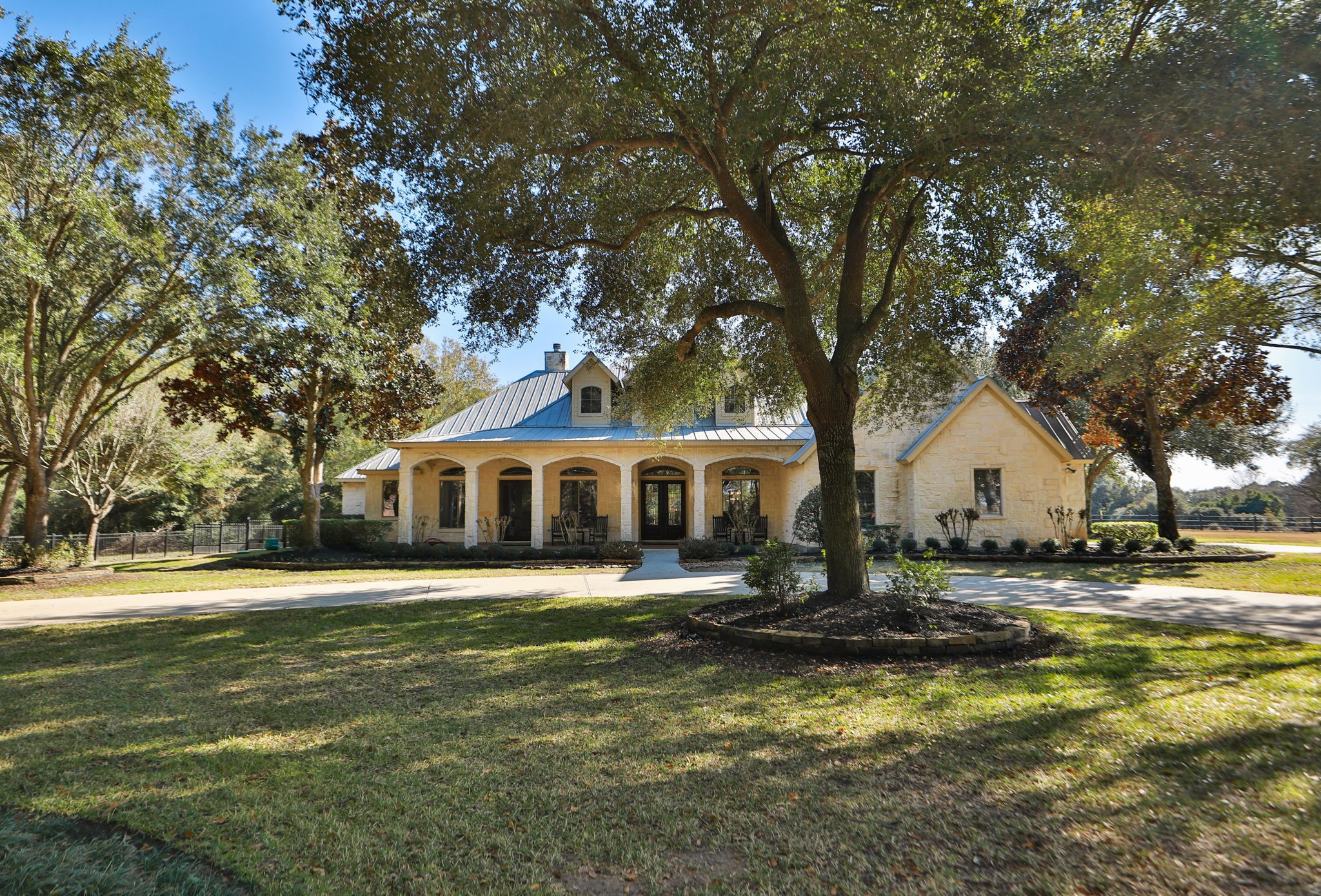 15601 Brown Road Tomball, TX 77377 - Photo 4 of 48 a front view of a house with a garden and trees