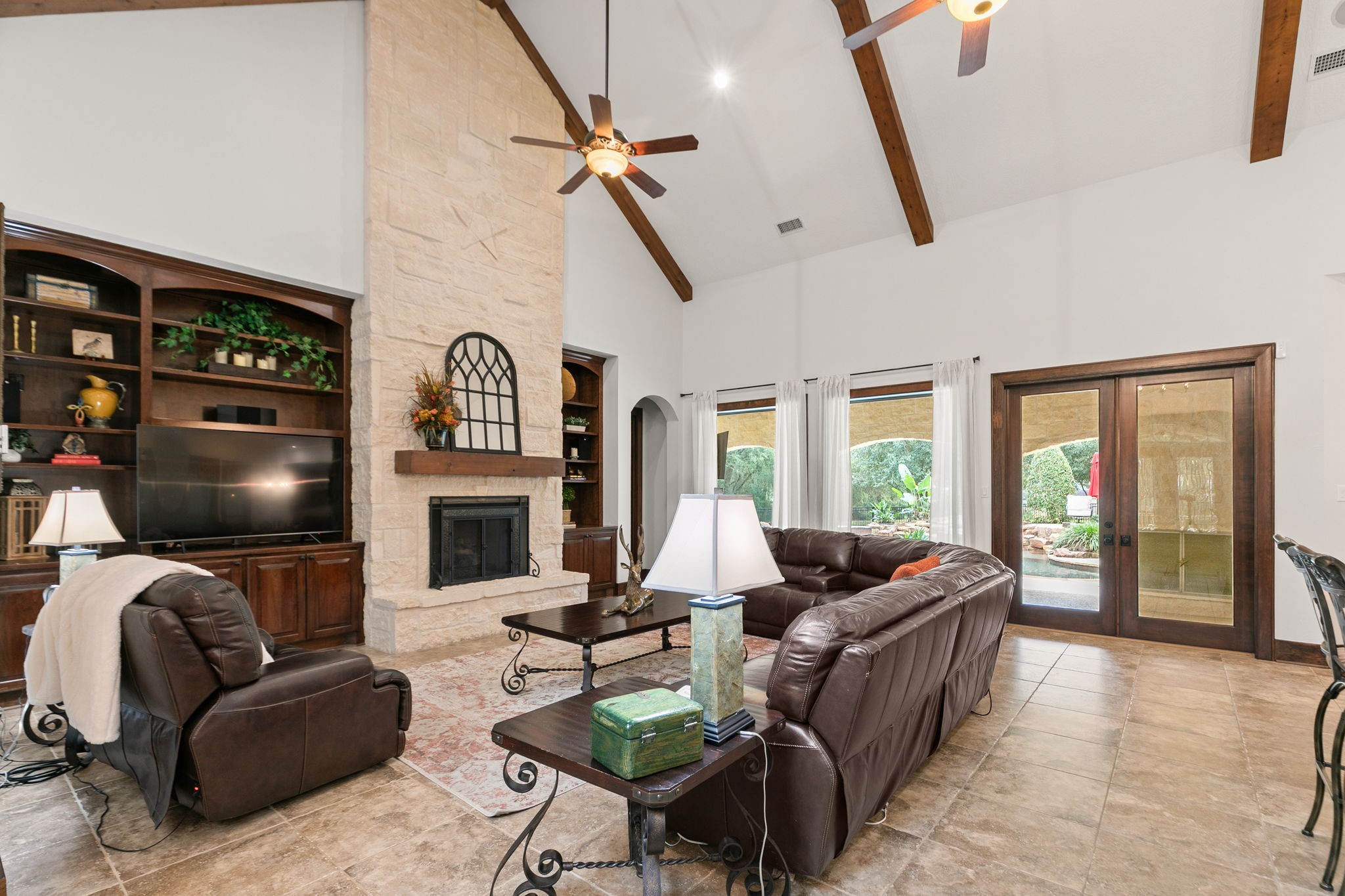 15601 Brown Road Tomball, TX 77377 - Photo 9 of 48 a living room with furniture a fireplace and a flat screen tv