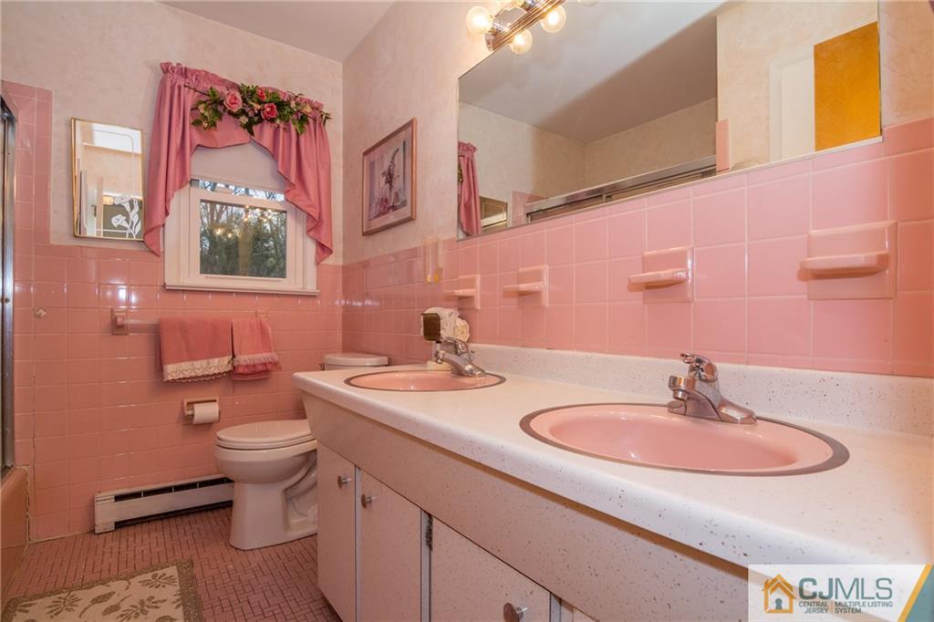 240 Hamlin Road North Brunswick, NJ 08902 - Photo 14 of 24 a bathroom with a toilet sink and mirror