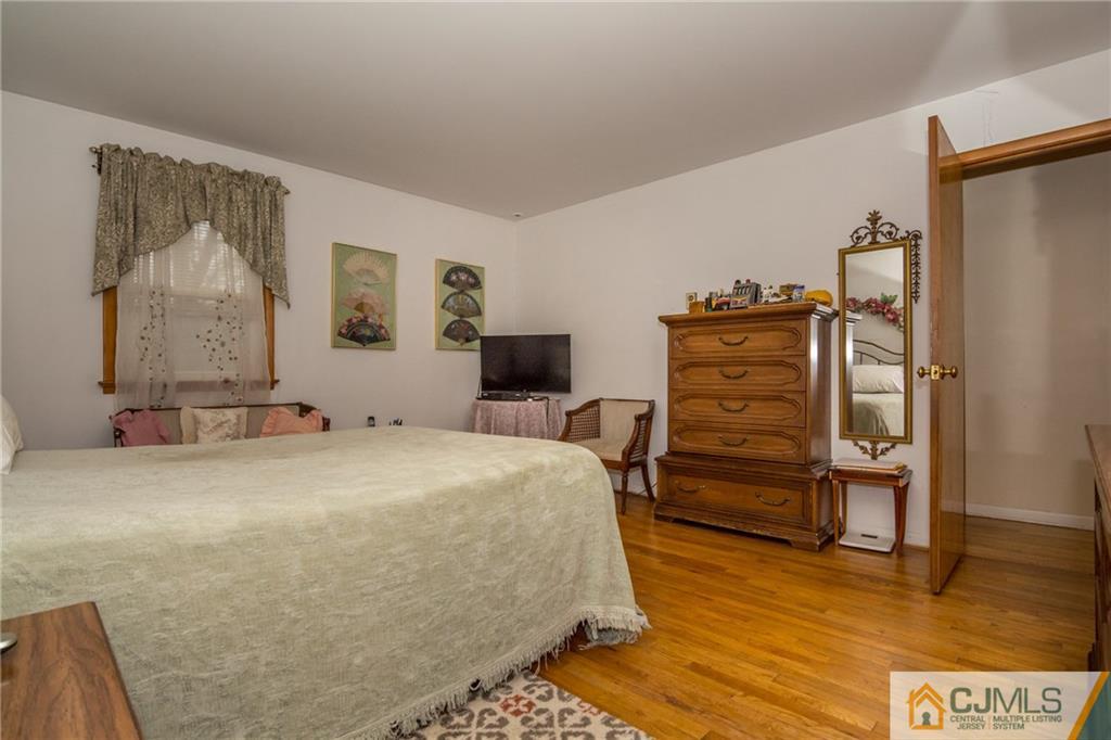 240 Hamlin Road North Brunswick, NJ 08902 - Photo 16 of 24 a bedroom with a bed and furniture