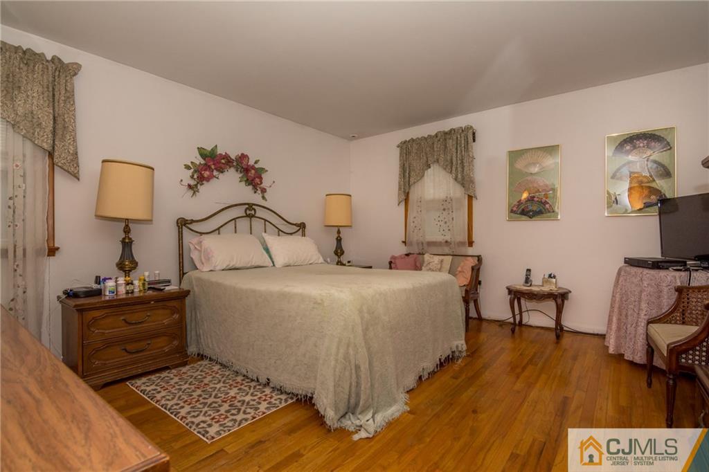 240 Hamlin Road North Brunswick, NJ 08902 - Photo 17 of 24 a bedroom with a bed and wooden floor
