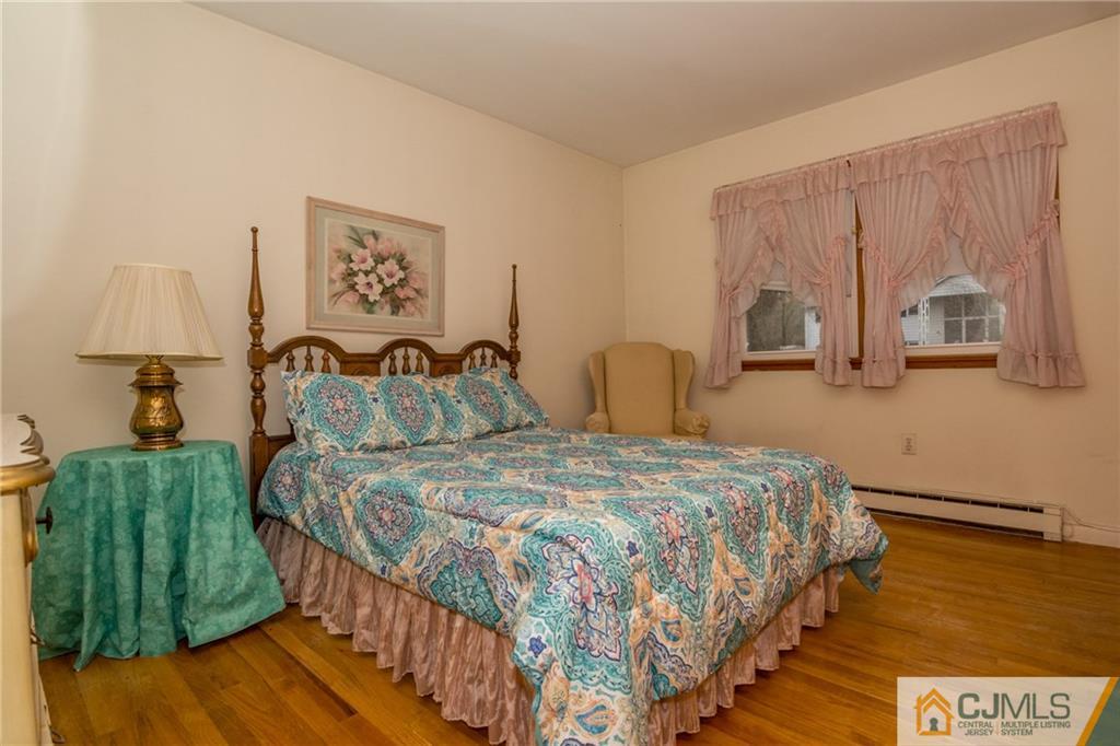 240 Hamlin Road North Brunswick, NJ 08902 - Photo 18 of 24 a bedroom with a bed and a painting on the wall