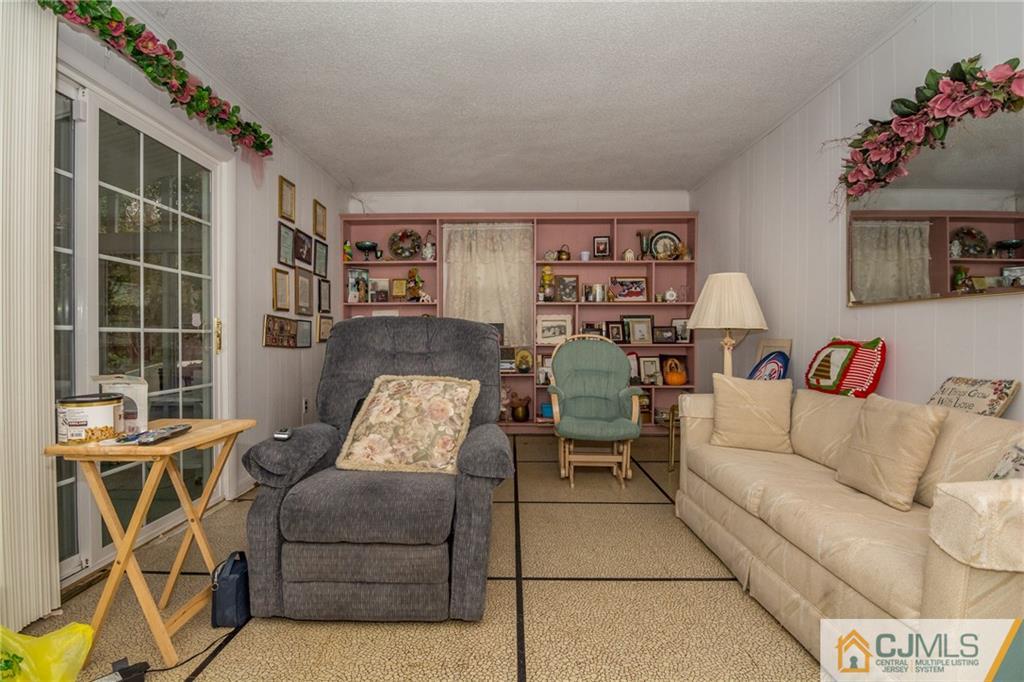 240 Hamlin Road North Brunswick, NJ 08902 - Photo 19 of 24 a living room with furniture and a floor to ceiling window