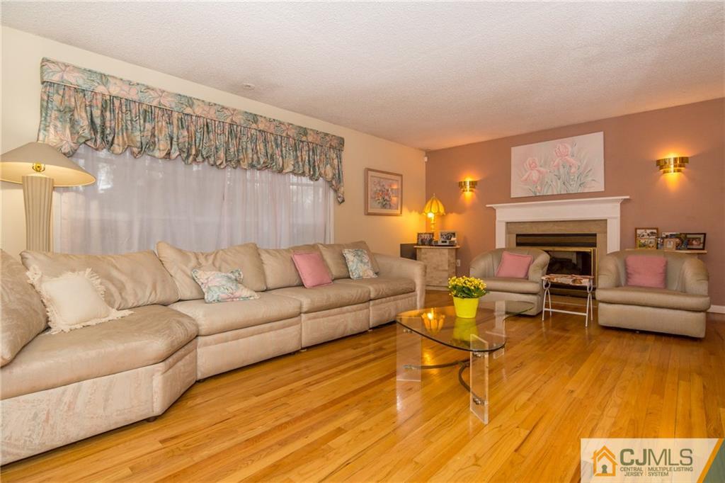 240 Hamlin Road North Brunswick, NJ 08902 - Photo 7 of 24 a living room with furniture and a fireplace