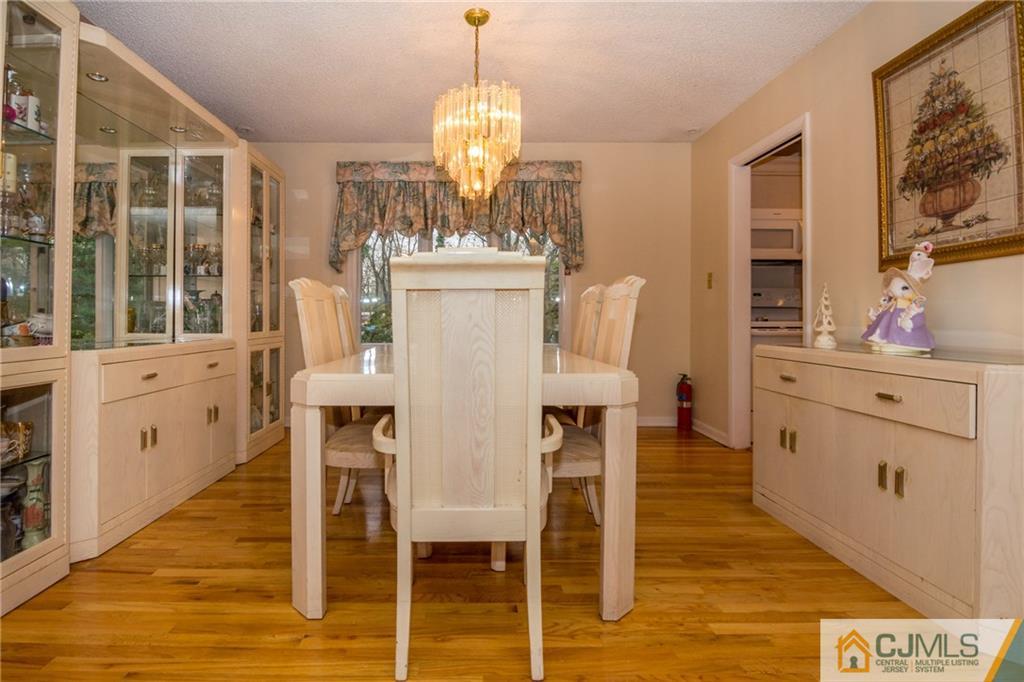 240 Hamlin Road North Brunswick, NJ 08902 - Photo 8 of 24 a view of a dining room with furniture and chandelier