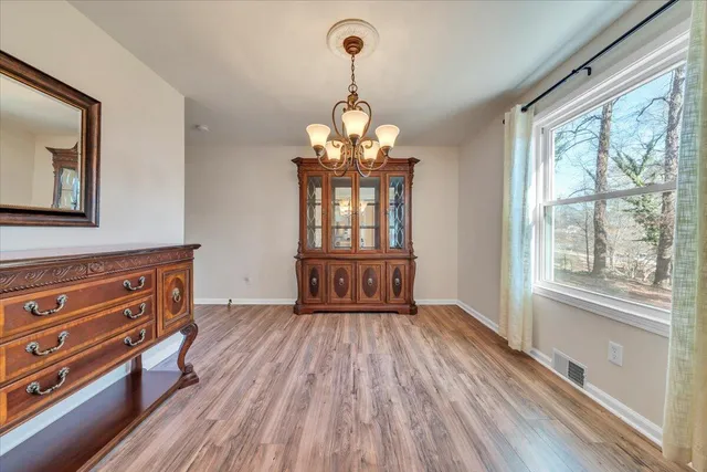a view of a room with wooden floor and cabinet