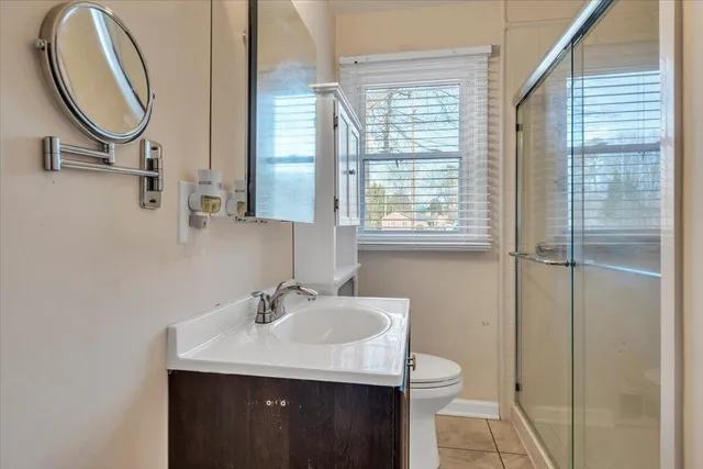 a bathroom with a sink a toilet and a mirror