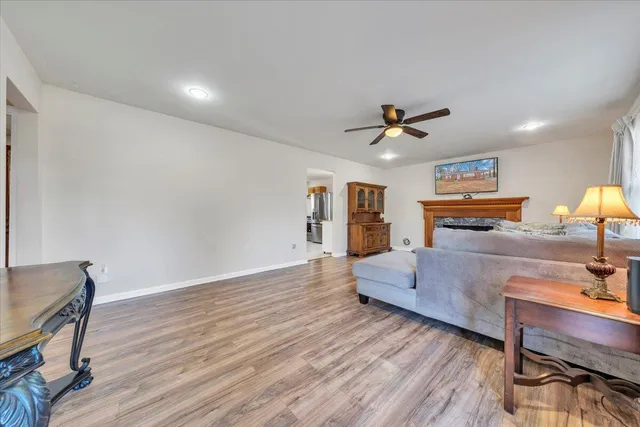 a living room with furniture and wooden floor