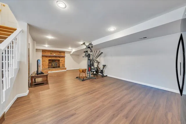 a view of a room with wooden floor and a chandelier