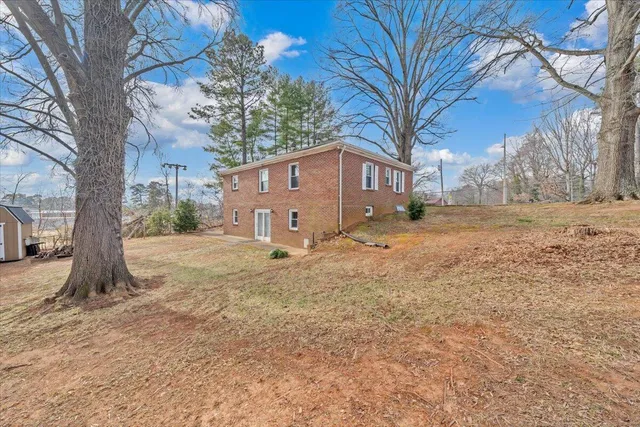 a view of a house with a yard covered in snow