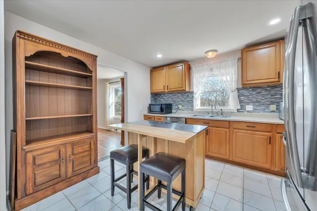 a kitchen with a sink cabinets and window