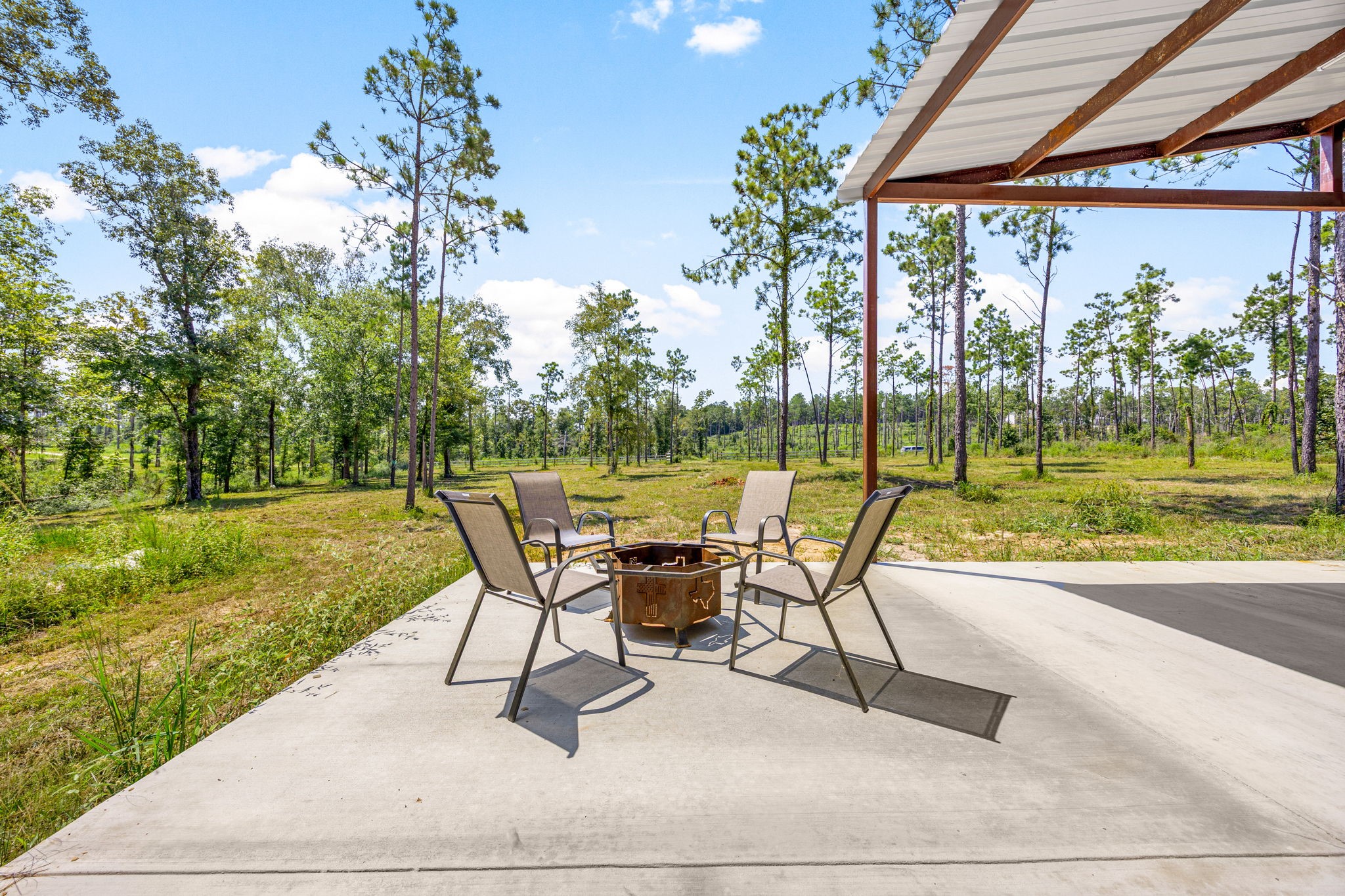 1100 Reveille Road Livingston, TX 77351 - Photo 12 of 20 a view of a patio with a table chairs and a garden